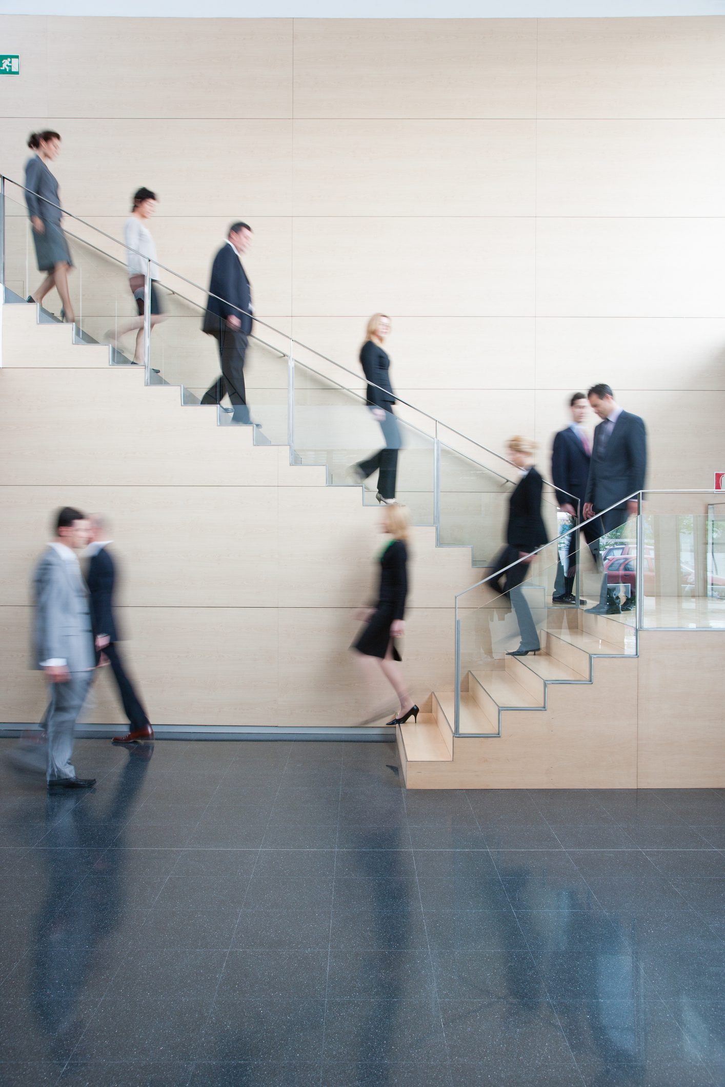 Blurry shot of people walking on the stairs
